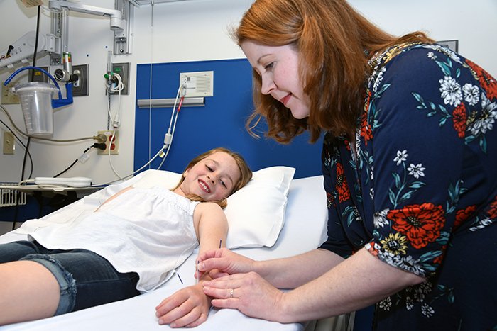 Jodie Manross, acupuncture specialist at East Tennessee Children's Hospital, treats a young patient